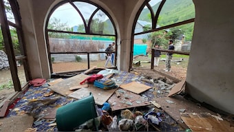 Men are seen through windowpanes of a residential house damaged by a cross-border shelling in Gingal village near the Line of Control (LoC) between India and Pakistan, in Kashmir's Baramulla district, May 9, 2025. Reuters Men are seen through windowpanes of a residential house damaged by a cross-border shelling in Gingal village near the Line of Control (LoC) between India and Pakistan, in Kashmir's Baramulla district, May 9, 2025. Reuters