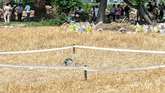 Villagers gather near the debris of a missile at a field on the outskirts of Amritsar. India's government said that Pakistan launched an overnight air attack using "drones and missiles", before New Delhi retaliated to destroy an air defence system in Lahore. AFP